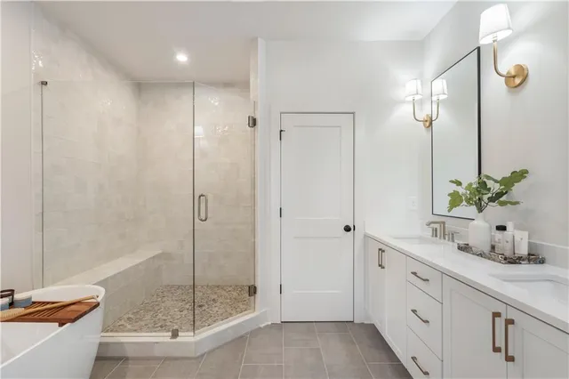 a bathroom with a granite countertop sink a mirror and a shower