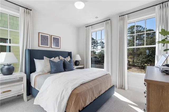 a bedroom with bed and a large window