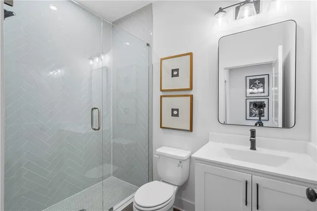 a bathroom with a toilet sink and shower