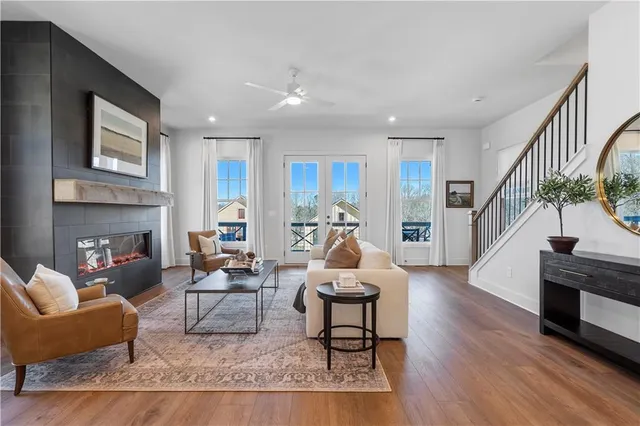 a living room with fireplace furniture and a wooden floor