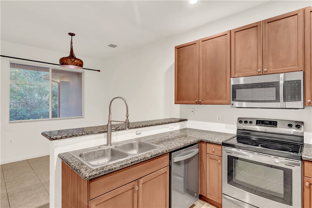 2541 Stockbridge Square Southwest Vero Beach, FL 32962 - Photo 16 of 33 a kitchen with granite countertop a sink stainless steel appliances and cabinets