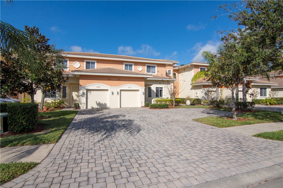 2541 Stockbridge Square Southwest Vero Beach, FL 32962 - Photo 2 of 33 a front view of a house with a yard and garage
