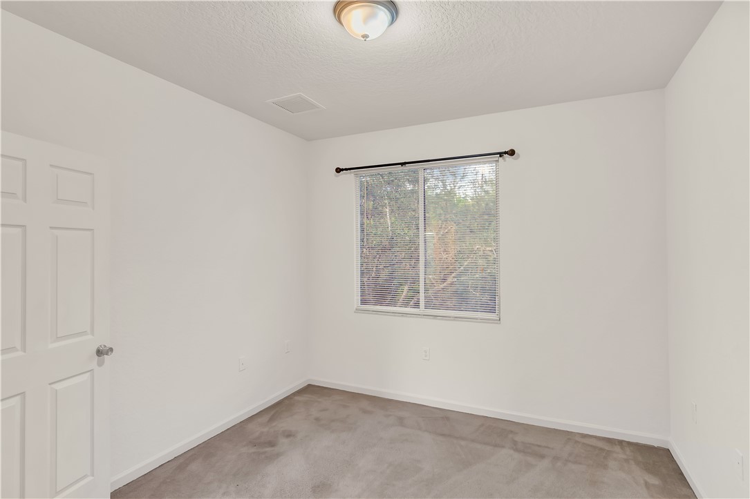 2541 Stockbridge Square Southwest Vero Beach, FL 32962 - Photo 24 of 33 an empty room with windows and closet