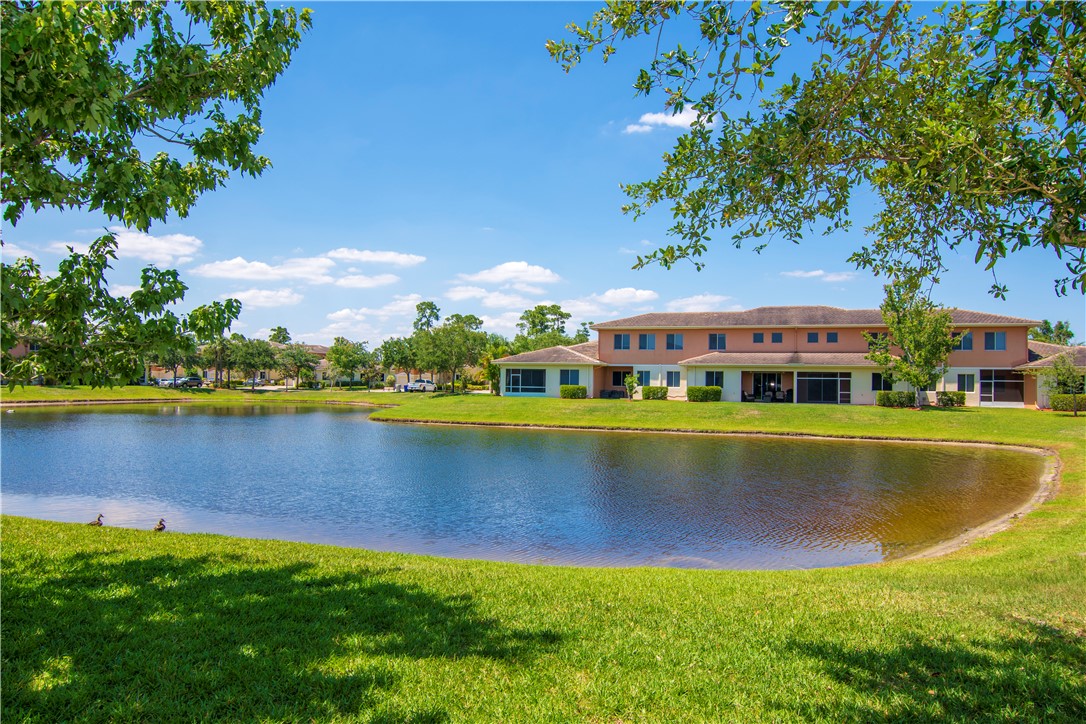 2541 Stockbridge Square Southwest Vero Beach, FL 32962 - Photo 33 of 33 a view of a house with swimming pool and a yard