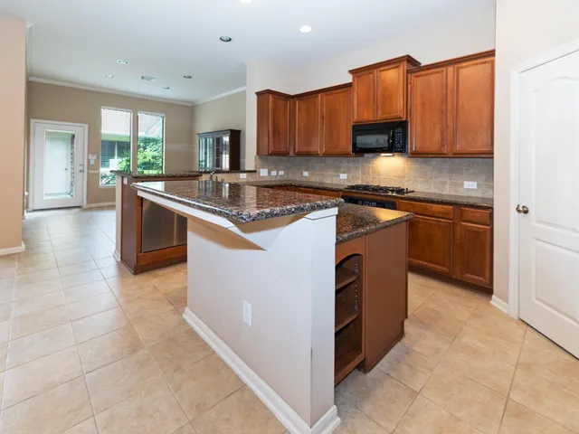 a kitchen with granite countertop cabinets and stainless steel appliances