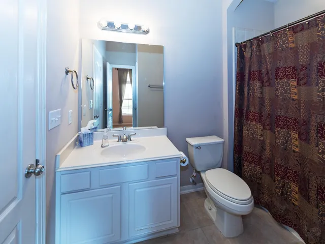 a view of an empty room with a ceiling fan