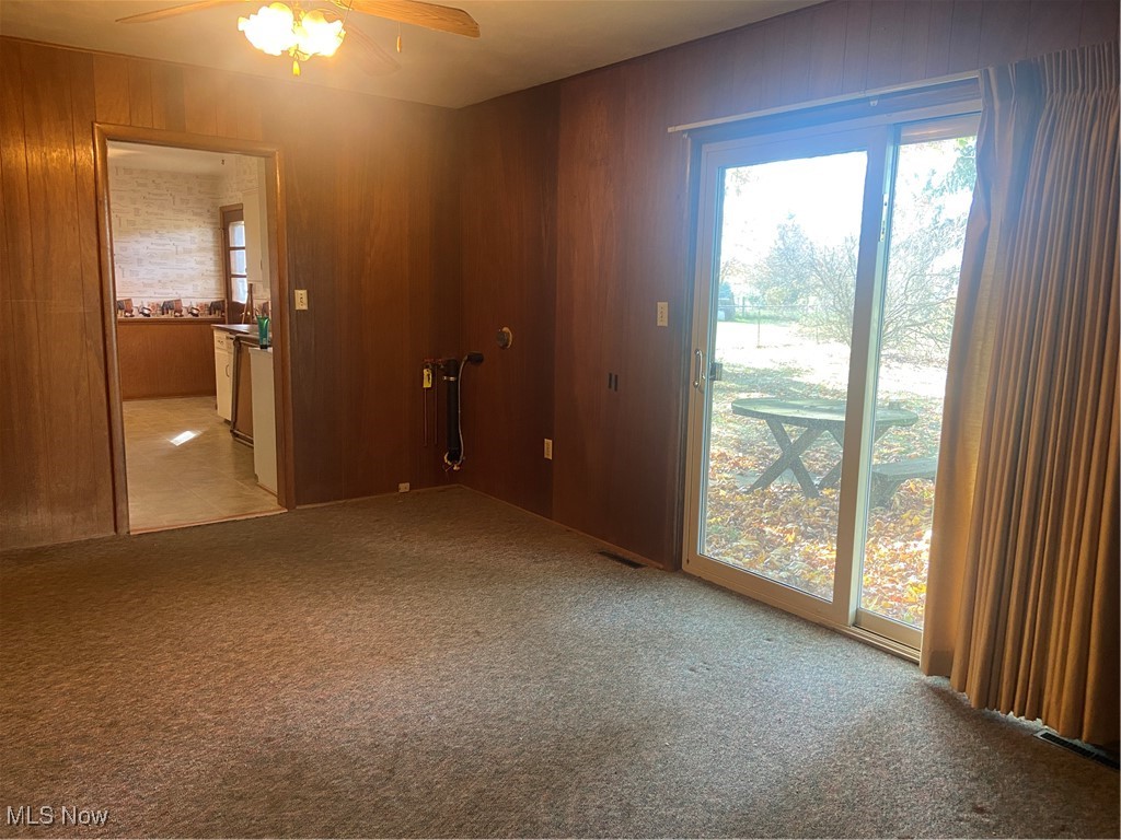 4842 Emalene Road Wooster, OH 44691 - Photo 15 of 30 Carpeted room featuring paneled walls and ceiling fan