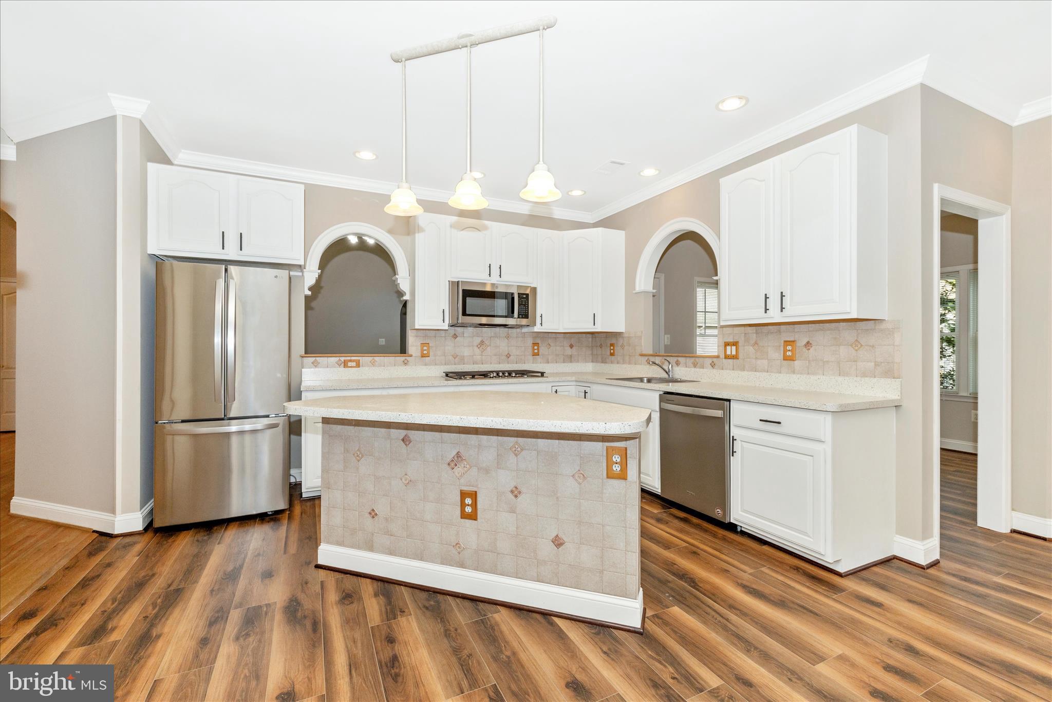 2654 Brook Valley Road Frederick, MD 21701 - Photo 12 of 64 a kitchen with white cabinets and stainless steel appliances