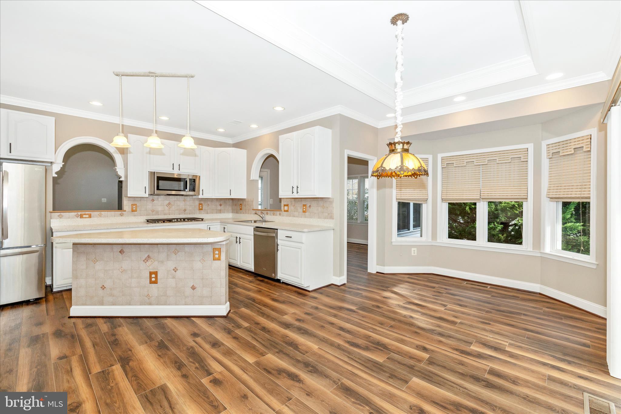 2654 Brook Valley Road Frederick, MD 21701 - Photo 17 of 64 a view of kitchen with stainless steel appliances granite countertop a stove a sink dishwasher and a dining table with wooden floor