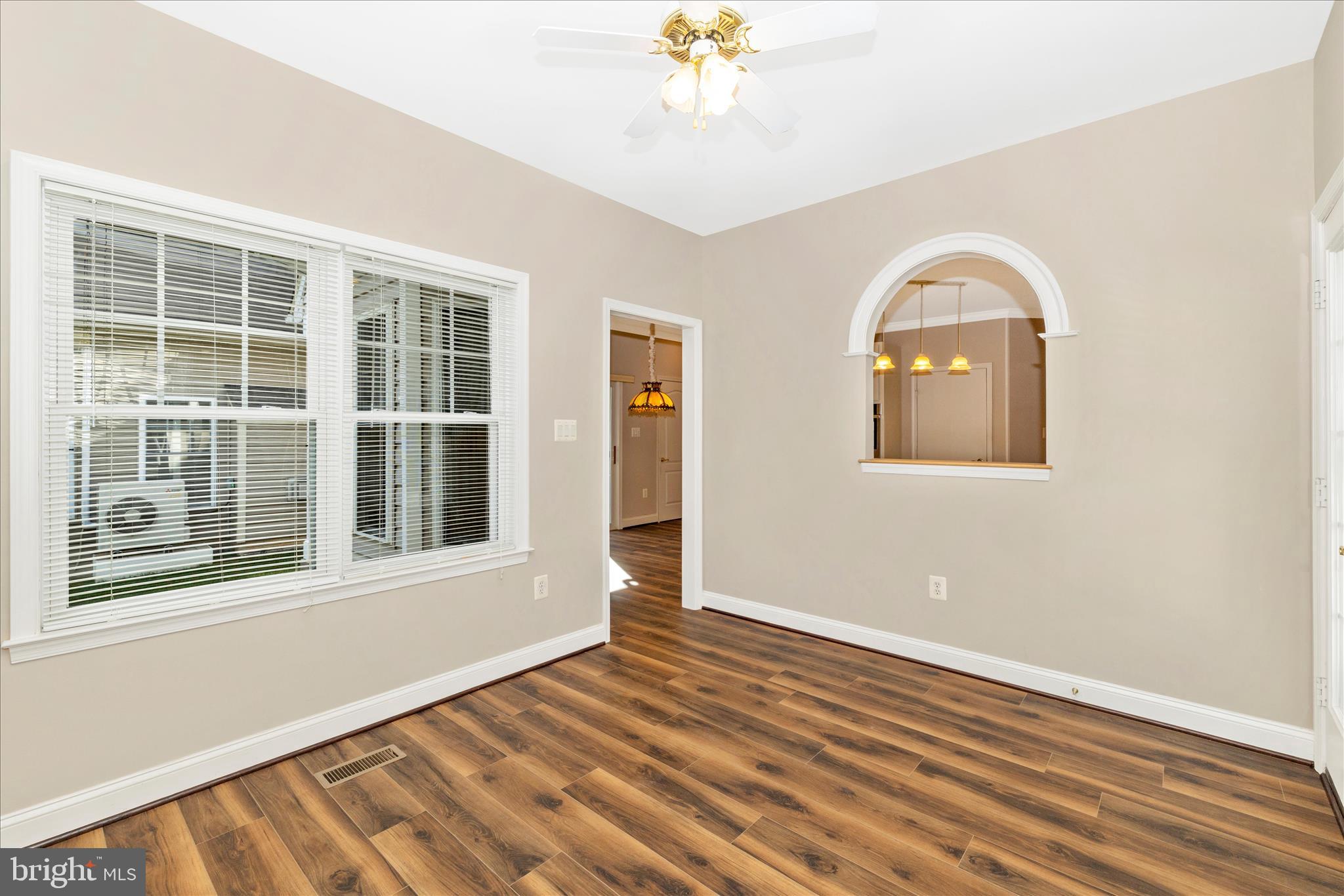 2654 Brook Valley Road Frederick, MD 21701 - Photo 21 of 64 an empty room with wooden floor chandelier and windows