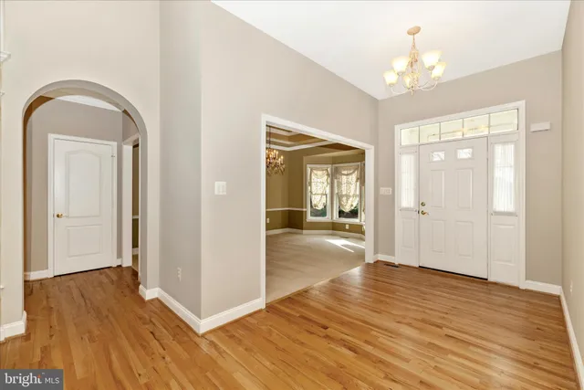 a view of a room with wooden floor and chandelier