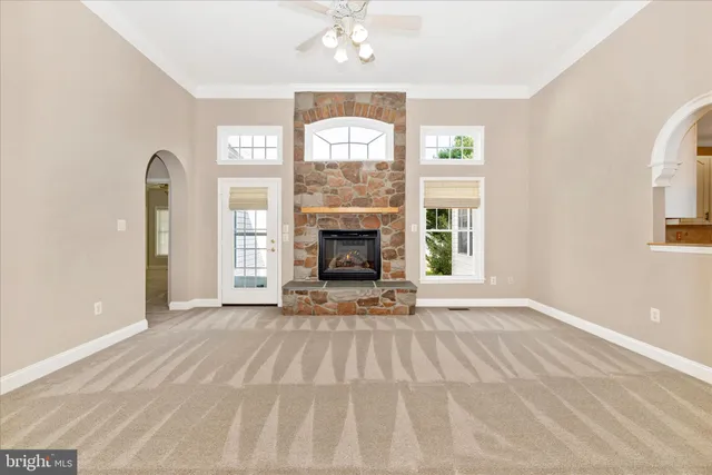 a large kitchen with a lot of counter space and wooden floor