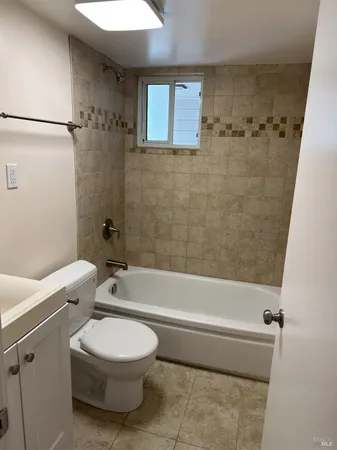 a bathroom with a toilet a sink and bathtub