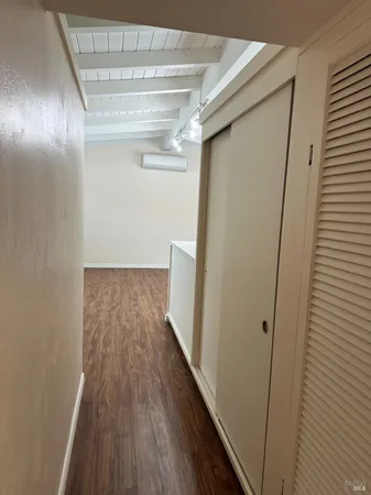 a view of hallway with wooden floor