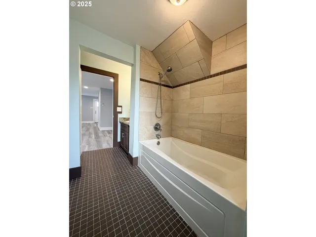 a bathroom with a bathtub and a shower