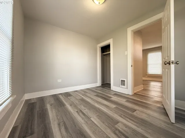 a view of an empty room and wooden floor