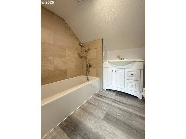 a bathroom with a sink a toilet and a bathtub