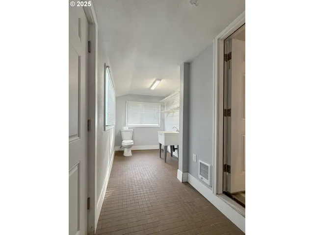 a view of a livingroom with wooden floor and a fireplace