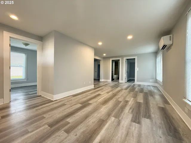 a view of an empty room and wooden floor