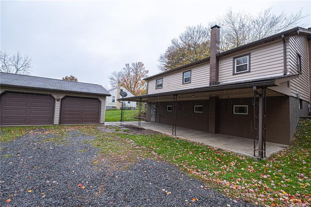 Back of the house entrance to the lower level, plenty of parking and covered porch