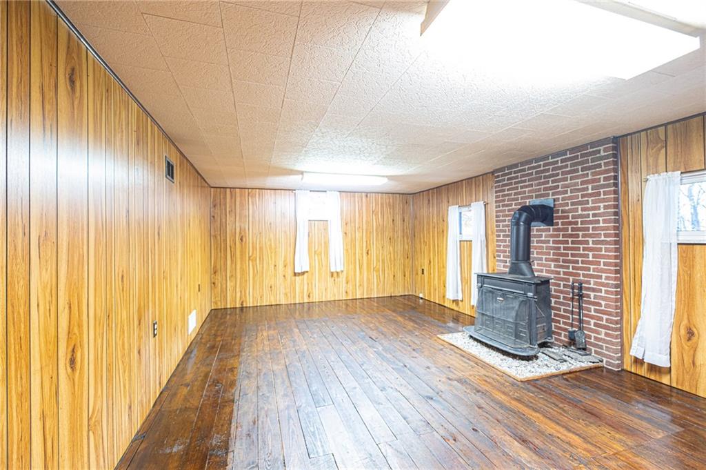 1252 Old Rte 18 Wampum, PA 16157 - Photo 14 of 22 Lower Level Family Room 24'x13' with a rustic wood stove