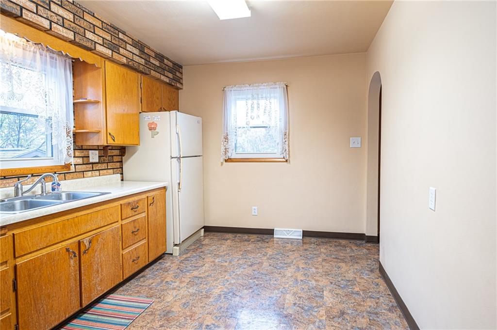 18'x10' This kitchen can host a kitchenette table along the wall, also has the entrance to lower level and side porch