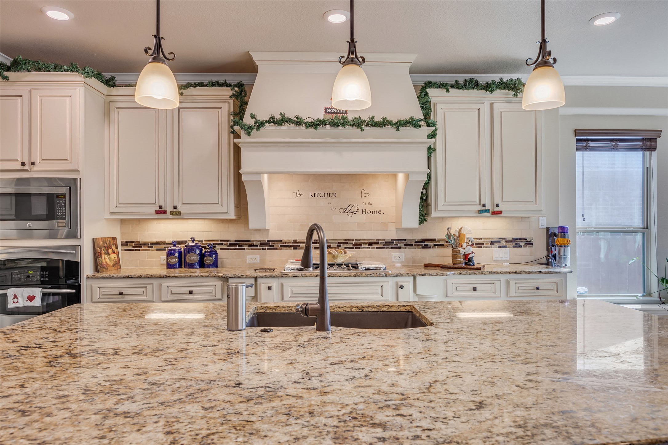 103 County Road 180, Unit 23 Leander, TX 78641 - Photo 14 of 40 Kitchen with hanging light fixtures, tasteful backsplash, appliances with stainless steel finishes, recessed lighting, and premium range hood