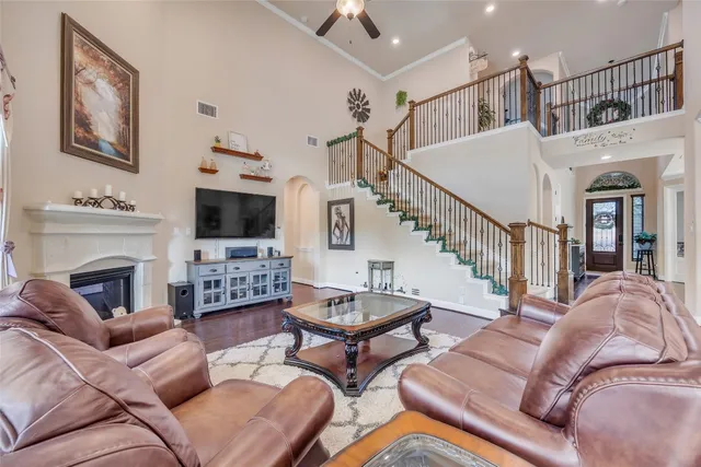 a living room with furniture a flat screen tv and a fireplace