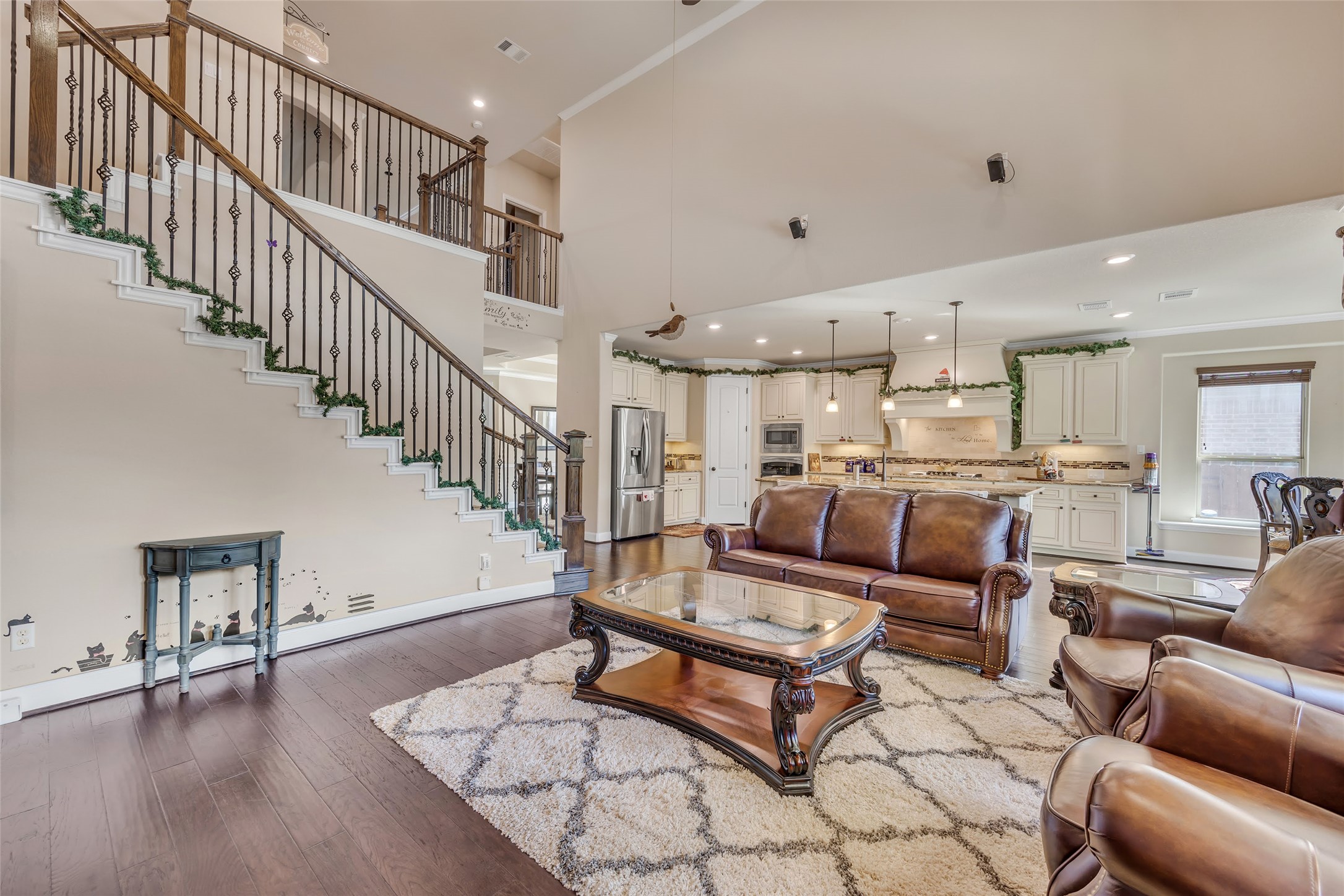 103 County Road 180, Unit 23 Leander, TX 78641 - Photo 17 of 40 Living room with stairway, dark wood finished floors, recessed lighting, ornamental molding, and a high ceiling