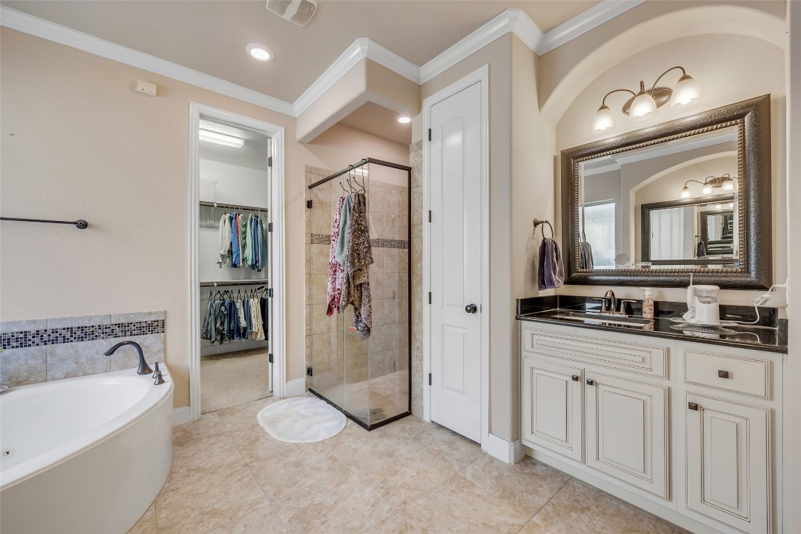 103 County Road 180, Unit 23 Leander, TX 78641 - Photo 19 of 40 a spacious bathroom with a double vanity sink and a mirror