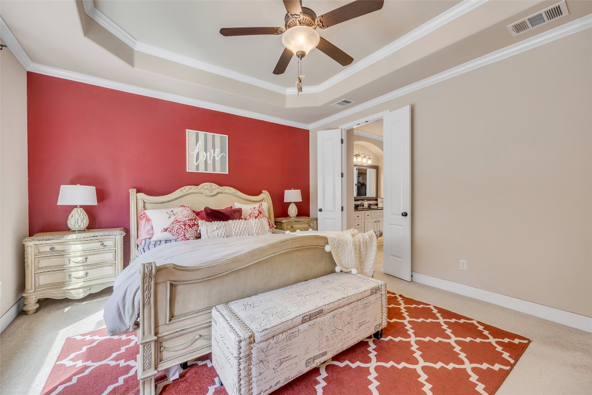 103 County Road 180, Unit 23 Leander, TX 78641 - Photo 30 of 40 a bedroom with a bed and a chandelier