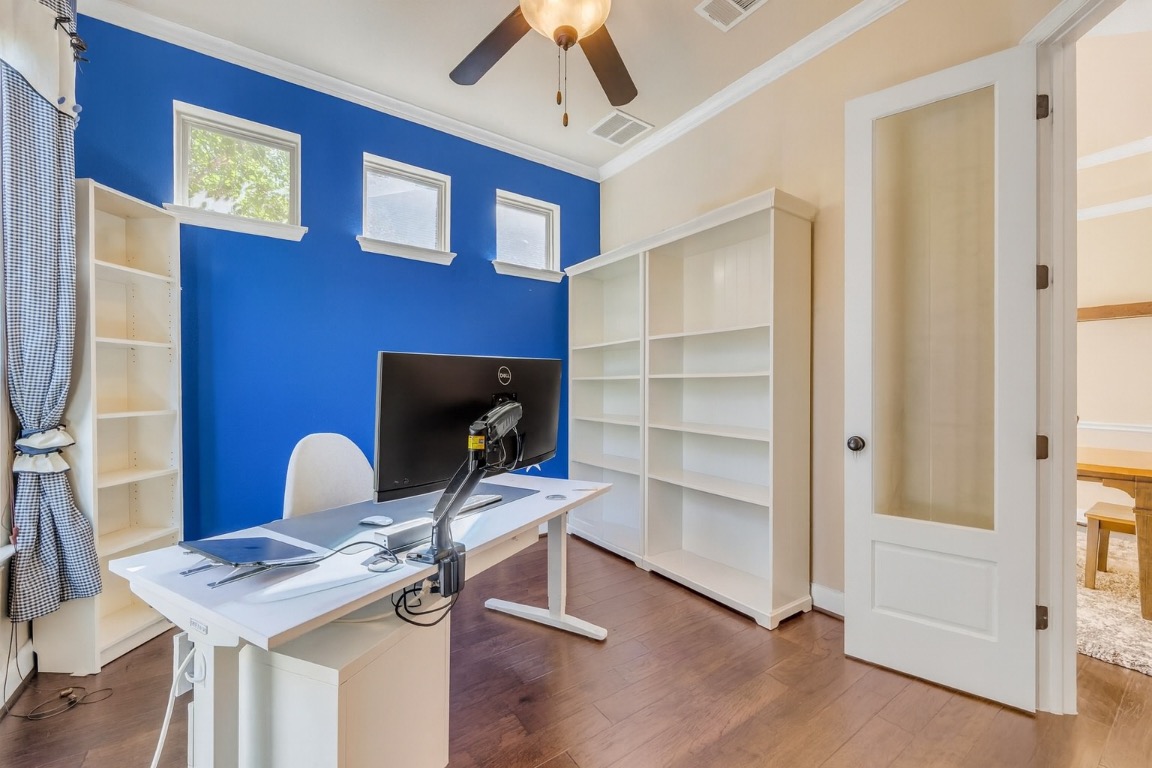 103 County Road 180, Unit 23 Leander, TX 78641 - Photo 39 of 40 a workspace with furniture and wooden floor