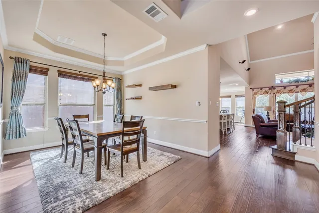 a view of a dining room with furniture and wooden floor
