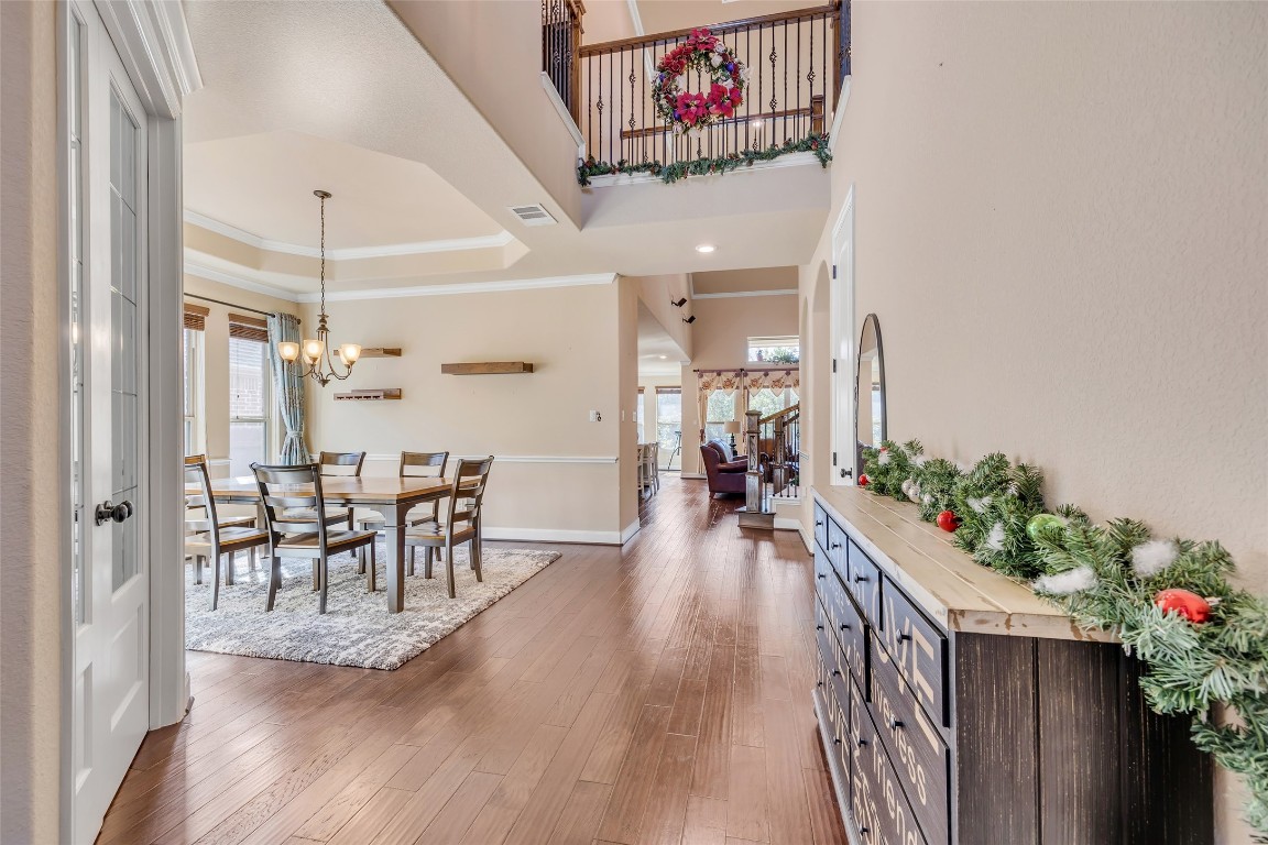 103 County Road 180, Unit 23 Leander, TX 78641 - Photo 7 of 40 an entryway dining room and hall with wooden floor