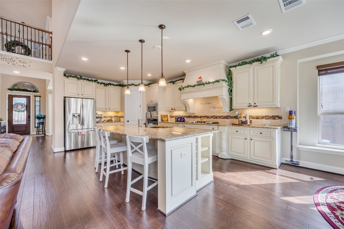 103 County Road 180, Unit 23 Leander, TX 78641 - Photo 9 of 40 a kitchen with white cabinets stainless steel appliances and kitchen island