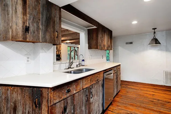 a kitchen with granite countertop a stove and a microwave