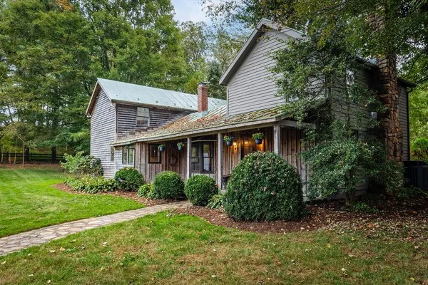 a view of a house with garden and yard