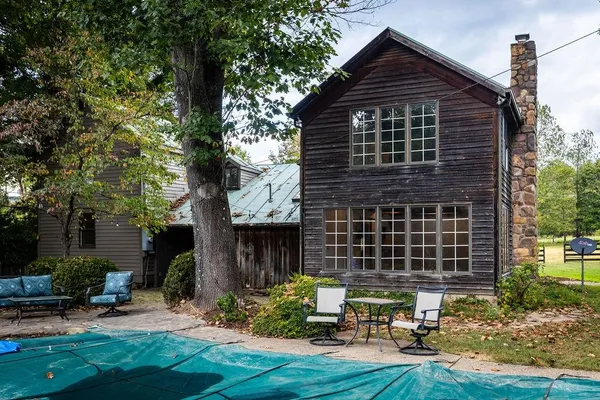 a view of backyard with table and chairs and potted plants