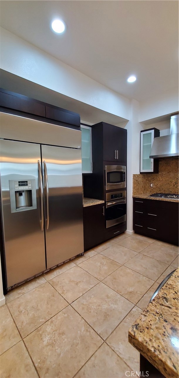 21 Gramercy, Unit 307 Irvine, CA 92612 - Photo 12 of 65 a large kitchen with granite countertop a stove and a refrigerator