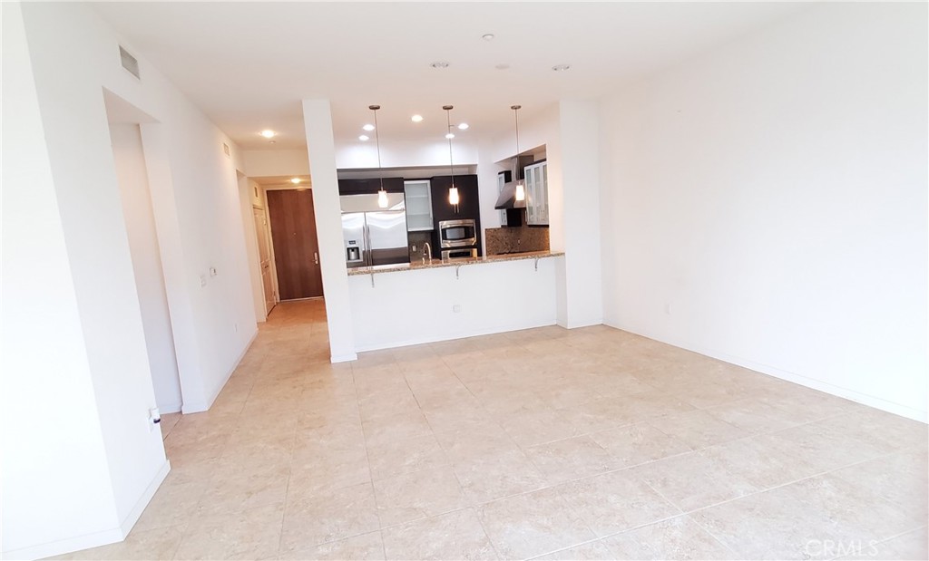 21 Gramercy, Unit 307 Irvine, CA 92612 - Photo 16 of 65 a view of a living room with furniture and a kitchen