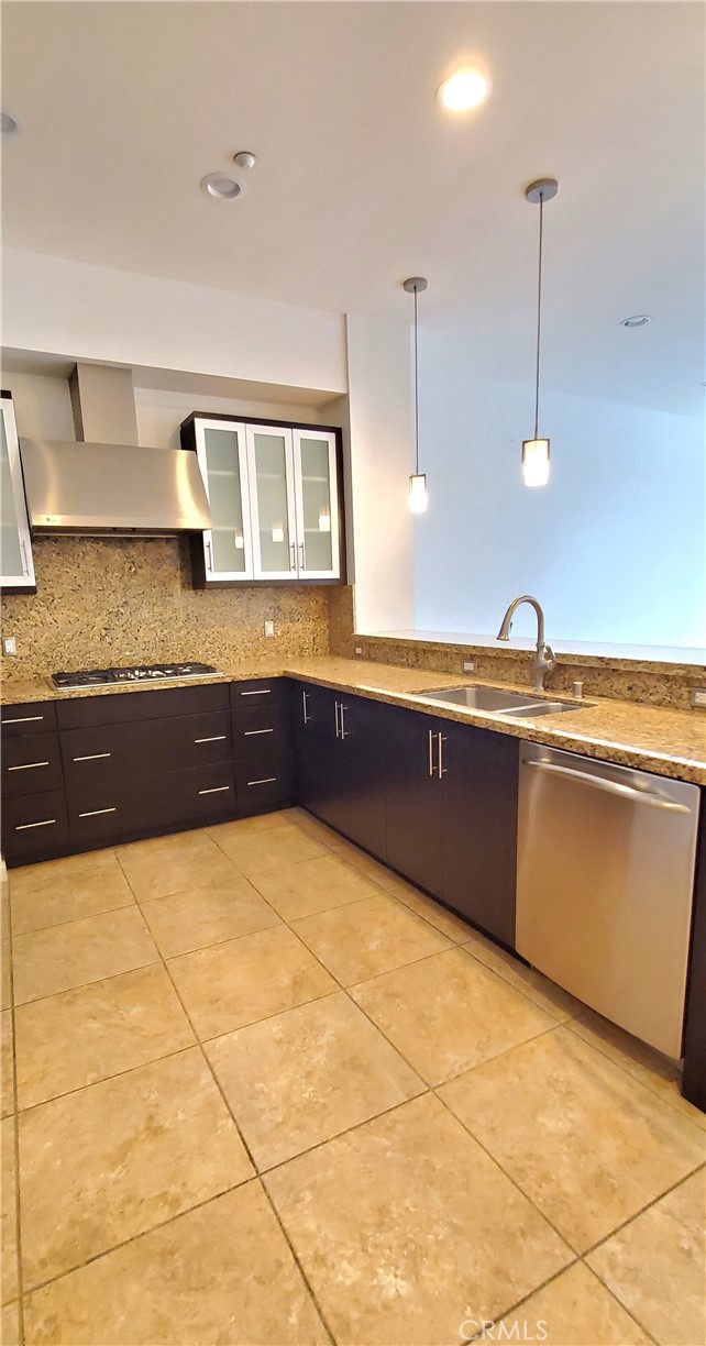 21 Gramercy, Unit 307 Irvine, CA 92612 - Photo 19 of 65 a kitchen with granite countertop a sink and a stove top oven