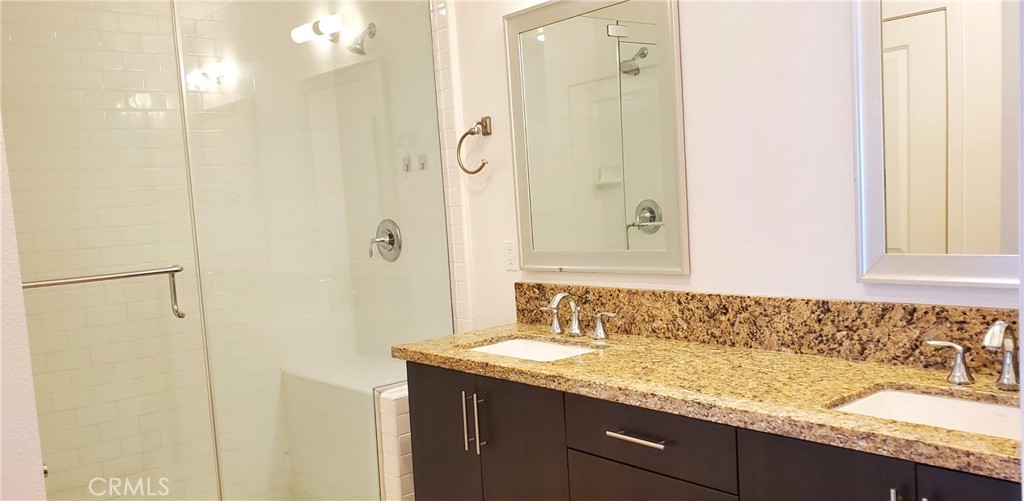 21 Gramercy, Unit 307 Irvine, CA 92612 - Photo 27 of 65 a bathroom with a granite countertop sink and a mirror