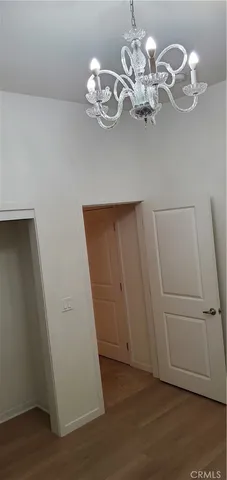 a view of a hallway with closet and a bathroom