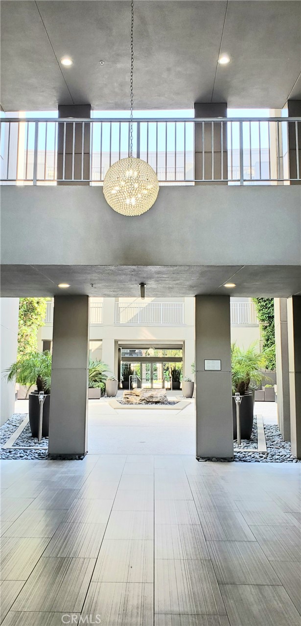 21 Gramercy, Unit 307 Irvine, CA 92612 - Photo 4 of 65 a view of a patio with a table and chairs and potted plants