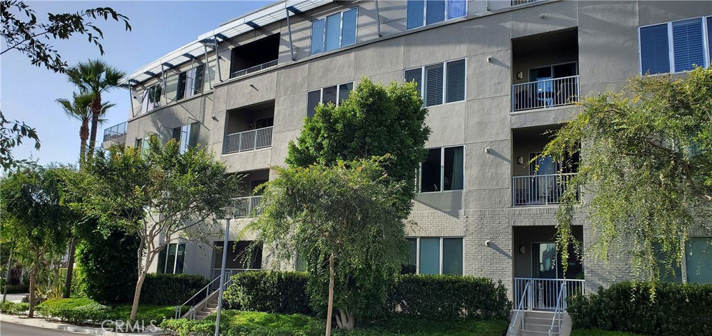 21 Gramercy, Unit 307 Irvine, CA 92612 - Photo 41 of 65 a front view of a house with plants and trees