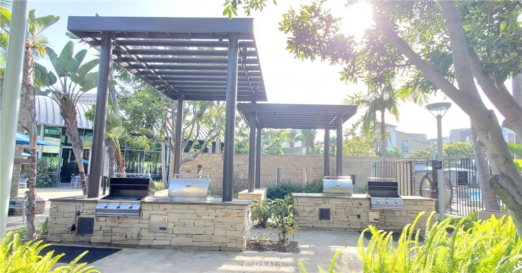 21 Gramercy, Unit 307 Irvine, CA 92612 - Photo 47 of 65 a view of a patio with couches table and chairs and potted plants