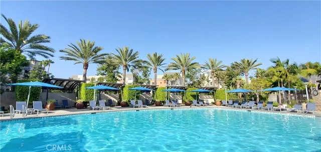 a kitchen with stainless steel appliances a stove and white cabinets