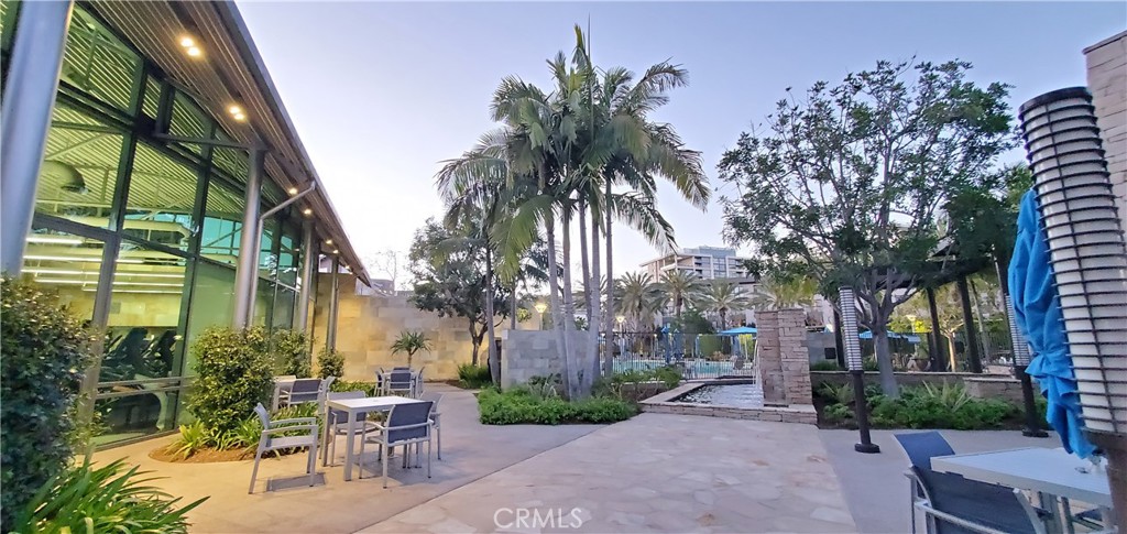 21 Gramercy, Unit 307 Irvine, CA 92612 - Photo 52 of 65 a row of palm trees in front of house