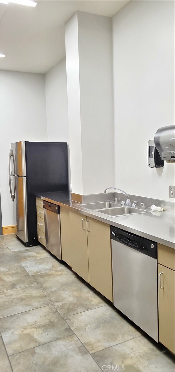 21 Gramercy, Unit 307 Irvine, CA 92612 - Photo 62 of 65 a kitchen with stainless steel appliances granite countertop a sink and a stove top oven