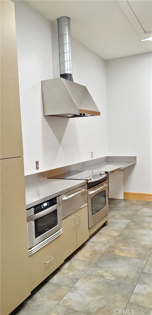 21 Gramercy, Unit 307 Irvine, CA 92612 - Photo 63 of 65 a kitchen with stainless steel appliances a stove and white cabinets
